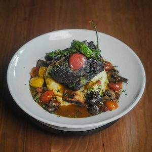 Black Angus beef, charred scallion chili butter, served with asparagus, and mushroom hash