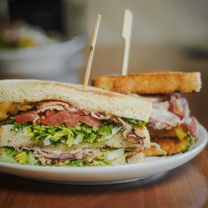 Roasted turkey, smoked ham, white cheddar, mayonnaise, smoked bacon, lettuce, tomato, served on toasted sourdough bread