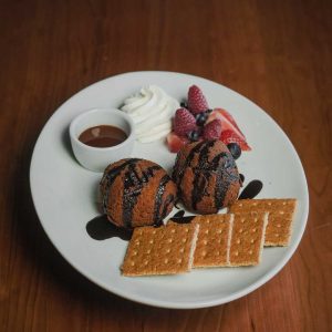 3 giant graham cracker breaded marshmallows, served with chocolate sauce, caramel sauce, and graham crackers.