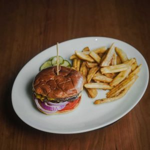 Two short rib and brisket ground beef patties, American cheese, tomato, red onion, served on potato bun