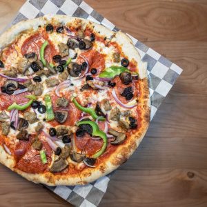 Italian sausage, pepperoni, mushrooms, red onion, peppers, black olives, with shredded mozzarella, and tomato sauce